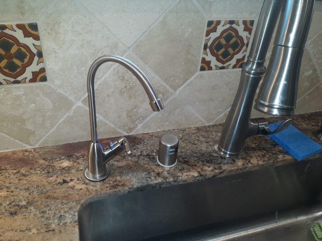 Reverse osmosis drinking water faucet installed at kitchen sink