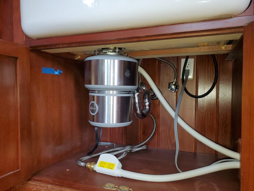 Garbage disposal installed under kitchen sink by VILVIX Plumbing Systems