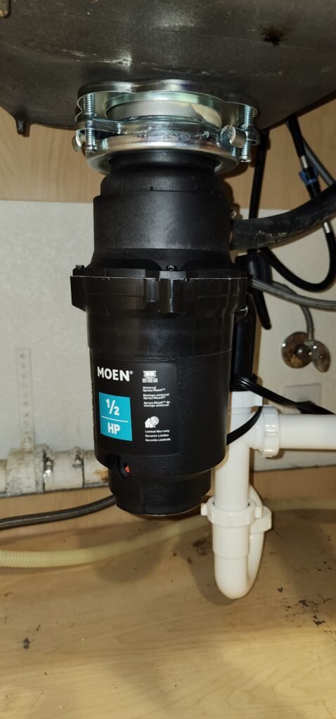 Garbage disposal replacement connected to kitchen sink drain
