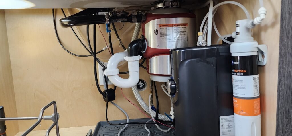 Garbage disposal installed under sink with water filtration system
