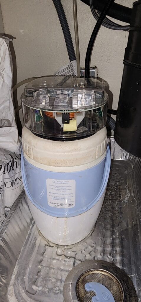 Water filtration system filter housing under sink