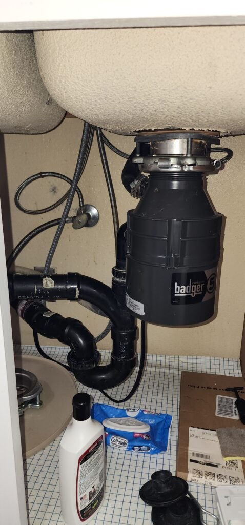 Insinkerator garbage disposal installed under kitchen sink