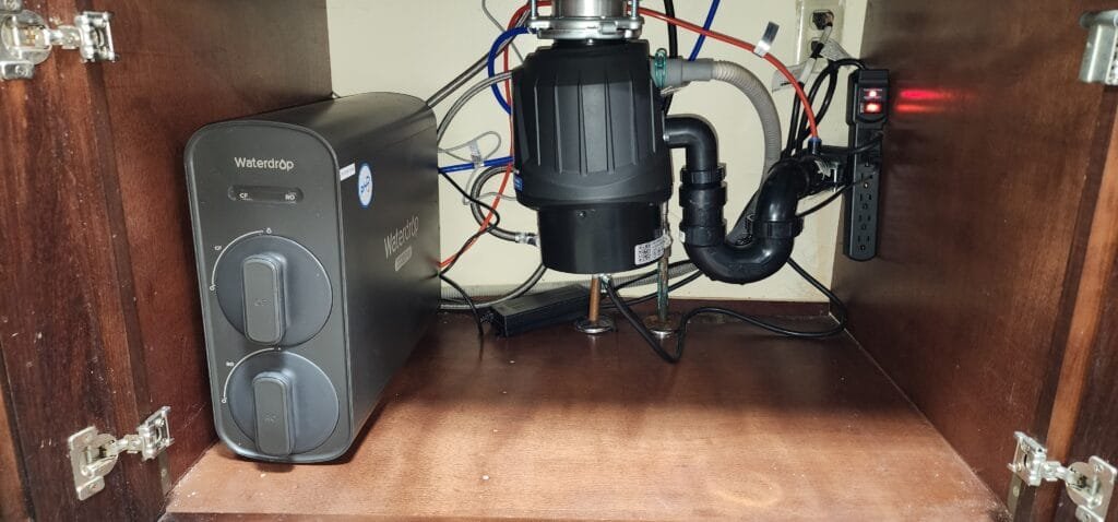 Under-sink water filtration system and plumbing connections